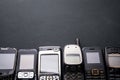 Old and obsoleted cellphones on black background Royalty Free Stock Photo