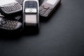 Old and obsoleted cellphones on a black background Royalty Free Stock Photo