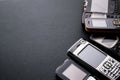 Old and obsoleted cellphones on a black background Royalty Free Stock Photo