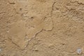 Old ochre painted stucco wall with cracked plaster. Background t Royalty Free Stock Photo