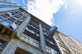 Old office building facade with clock and cloudy sky Royalty Free Stock Photo