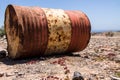 Old oil barrel in the sand