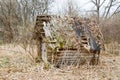 Old old dilapidated little wooden abandoned ruined rickety broken village house of beams, logs and sticks in the wilderness Royalty Free Stock Photo