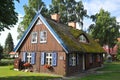 Old old wooden house, red, in the European country of Lithuania, in the spa town of Nida, on the Curonian Spit Royalty Free Stock Photo