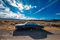 Old Oldsmobile 88 Car in Nevada Desert with blue sky on a sunny day