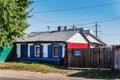 Old one-story private house with wooden gates. Old autumn city. Shevchenko street