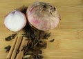 Old onions with different spices set on  wood plate.Top view Royalty Free Stock Photo