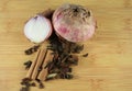 Old onions with different spices set on  wood plate.Top view Royalty Free Stock Photo