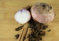 Old onions with different spices set on  wooden plate.Top view Royalty Free Stock Photo