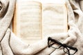 Old open book, glasses and sweater Royalty Free Stock Photo