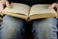 An old open book at his feet. A man is reading a book lying on his feet Royalty Free Stock Photo