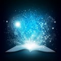 Old open book with magic light and falling stars Royalty Free Stock Photo