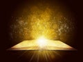 Old open book with magic light and falling stars Royalty Free Stock Photo
