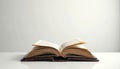 Old open book rests on light reflective table. Aged pages display text, suggesting deep study, wisdom. Classic vintage volume Royalty Free Stock Photo