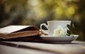 Old open books and a cup with a white wild rose Royalty Free Stock Photo