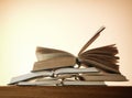 Old open novel books on a wooden table