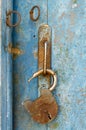 Old open padlock rusty on wooden weathered door Royalty Free Stock Photo