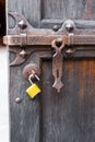 Old open wooden door carved forged deadbolt open attachments modern yellow padlock