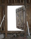 Old open wooden door with empty white space behind. Abandoned attic wooden wall with garbage as a template for backspace Royalty Free Stock Photo