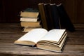 Old opened antique books on a wooden table.