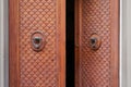 Old opened wooden door with bronze knockers in Florence, Italy Royalty Free Stock Photo