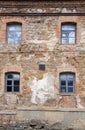 Old orange brick wall with four windows Royalty Free Stock Photo