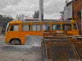 Old orange bus style of the 60s on scrap metal. Old fashioned abandoned bus