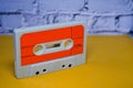 Old orange cassette tape on yellow Royalty Free Stock Photo