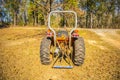 Old orange  farm tractor rear view Royalty Free Stock Photo