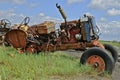 Old orange junked tractor for parts and salvage