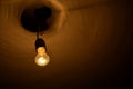Old orange light bulb on the ceiling Royalty Free Stock Photo