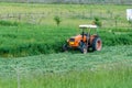 Old orange tractor on freshly cutted grass