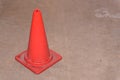 Old orange traffic cones stand on the cement road Royalty Free Stock Photo