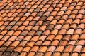 Old orange weathered roof shingles. Dirty stained ceramic tiles Royalty Free Stock Photo
