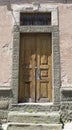 Old orange wooden door with stone frame Royalty Free Stock Photo