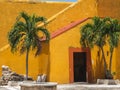 Old orange and yellow door and stairs of a Spanish-colonial style building in Mexico Royalty Free Stock Photo