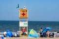 Crowded colorful beach with people, beach umbrellas and sunbeds, summer vacations and tourism concept