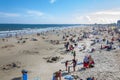 Crowded colorful beach with people, beach umbrellas and sunbeds, summer vacations and tourism concept