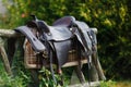 Old ornamental saddle on the wooden fence Royalty Free Stock Photo