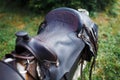 Old ornamental saddle on the wooden fence Royalty Free Stock Photo