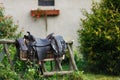 Old ornamental saddle on the wooden fence Royalty Free Stock Photo