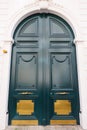 Old ornate door in Paris - typical old apartment buildiing. Royalty Free Stock Photo