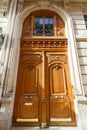Old ornate door in Paris - typical old apartment buildiing. Royalty Free Stock Photo