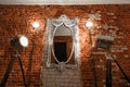 Old ornate frames on mirror glas hanging a brick wall. Royalty Free Stock Photo