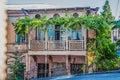 Old ornate grungy house in Tbilisi Georgia covered with grape vines