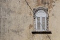 Old ornate window crossed by a shadow Royalty Free Stock Photo