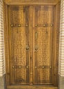 Old ornate wooden door with beautiful carvings Royalty Free Stock Photo