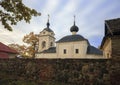 Old Orthodox church behind natural stone wall against background of the northern autumn sky