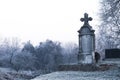 Old Orthodox cross tombstone in forest as scary Helloween cemetery