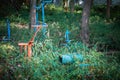 Old outdoor exercise equipment so worn out and covered in trees in outdoor exercise park. Old abandoned gym equipment on sports Royalty Free Stock Photo